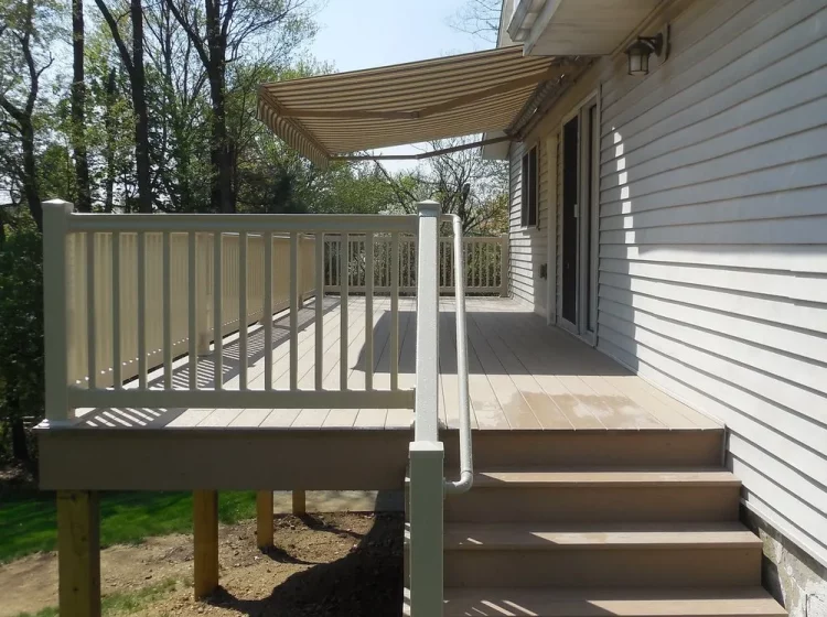 A cozy, covered wooden deck providing a shaded outdoor space with built-in seating, perfect for enjoying the outdoors and entertaining guests in a serene environment.